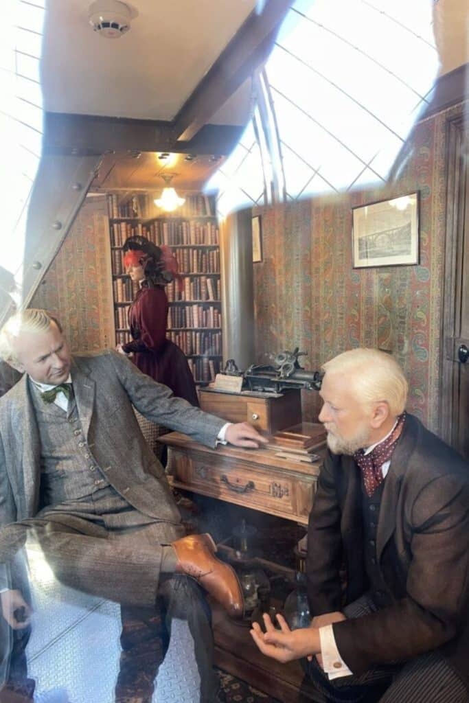 Wax figures inside Gustave Eiffel’s secret apartment at the top of the Eiffel Tower, one of the hidden gems in Paris that lets visitors peek into the engineer’s private study filled with books, vintage furniture, and scientific instruments.