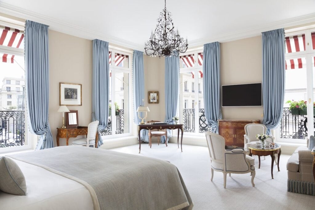 Bright and spacious suite with balcony at Paris Hotels with Connecting Rooms featuring elegant furnishings, large windows, and classic décor.