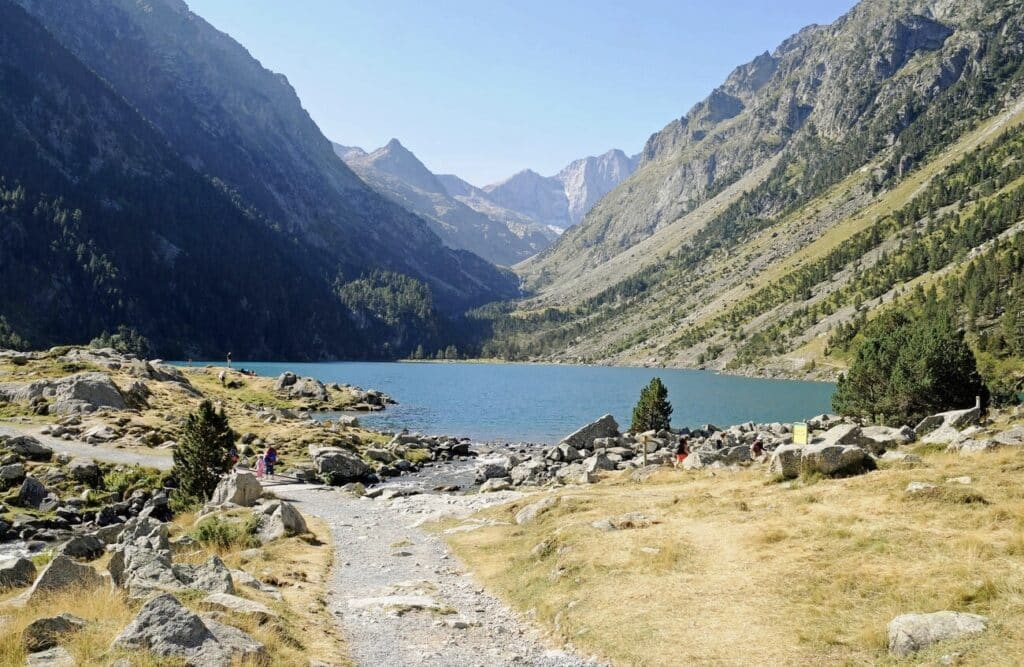 Hiking to the stunning Lac de Gaube, surrounded by towering Pyrenees mountains, is one of the top things to do in Occitanie France.