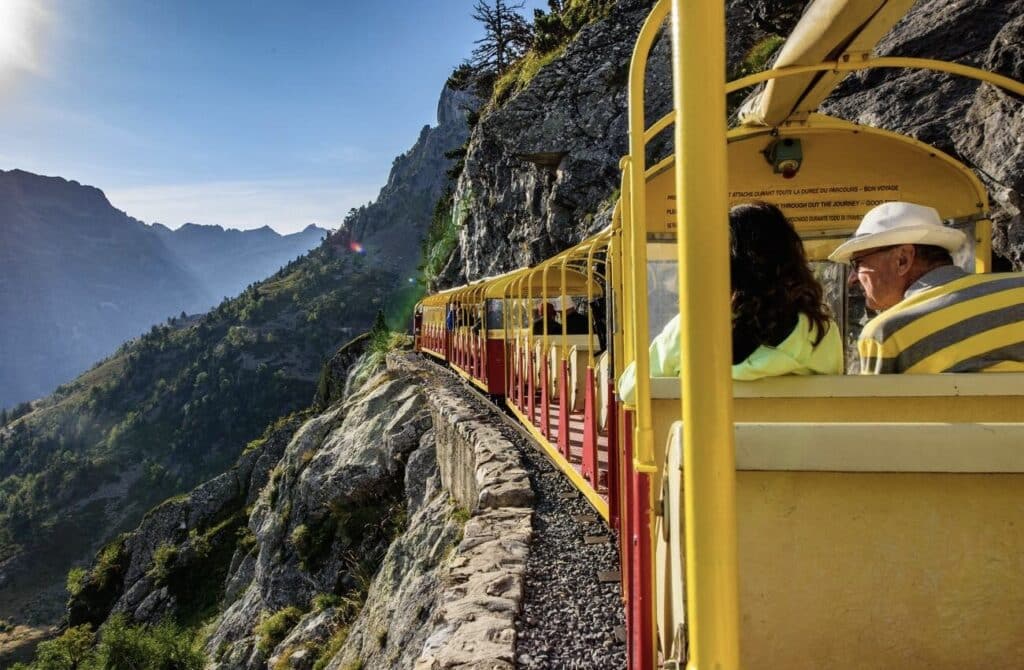 Riding the Petit Train d'Artouste, a scenic mountain railway with breathtaking views of the Pyrenees, is one of the most unforgettable things to do in Occitanie France.