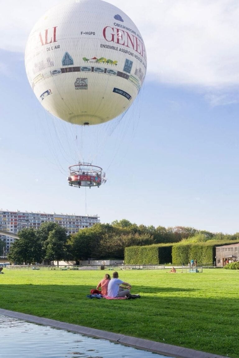 The Ballon de Paris Generali hot air balloon rising over Parc André Citroën, one of the hidden gems in Paris where visitors can enjoy panoramic city views from a tethered balloon ride.