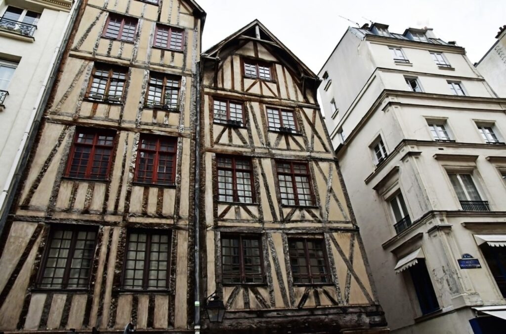 Historic timber-framed medieval houses in the Marais district, some of the oldest buildings in the city and unique hidden gems in Paris that reveal a glimpse of its medieval past.