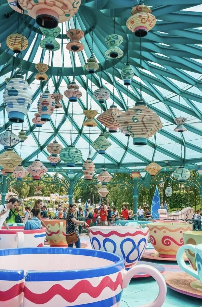 The whimsical Mad Hatter's Tea Cups ride at Disneyland Paris, with oversized colorful teacups and lanterns, perfect for those seeking 'Disneyland Paris on a Budget' magical moments.