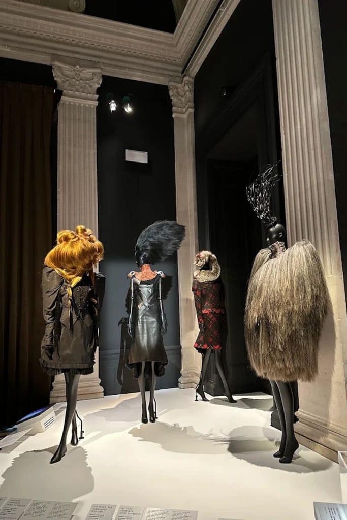 Mannequins wearing dramatic black, red, and textured designs inside Palais Galliera.