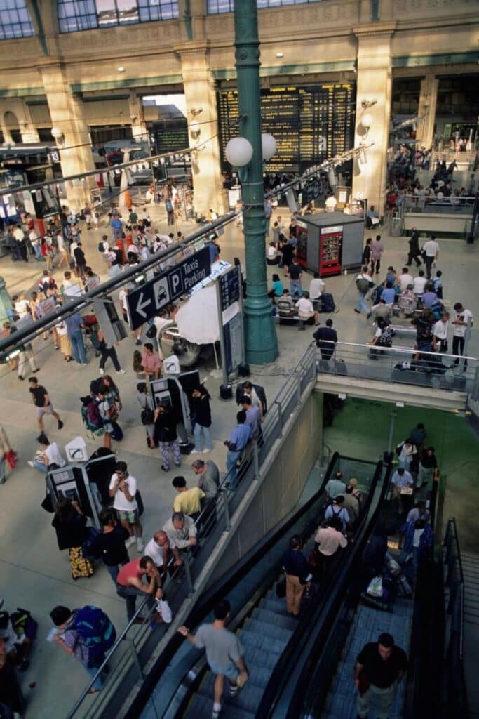 Crowds of travelers navigate Gare du Nord, one of the busiest train stations and a hotspot often cited among the dangerous neighborhoods in Paris due to its high rates of pickpocketing and petty crime.