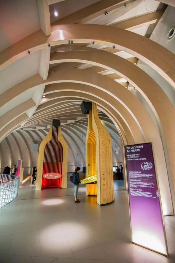A visitor explores the interactive exhibits at La Cité du Vin, Bordeaux’s world-renowned wine museum, making it an essential stop for wine lovers looking for unique things to do in Bordeaux.