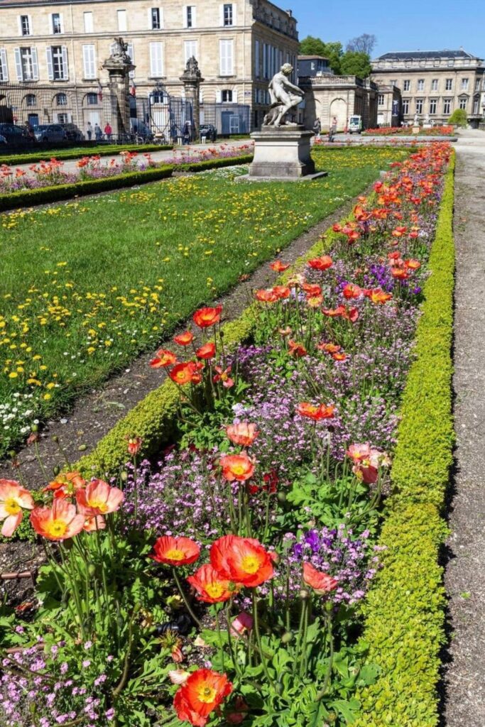 Bright flowers bloom in the Jardin Public of Bordeaux, a historic park with elegant landscaping and sculptures, making it a top choice for relaxing among the many things to do in Bordeaux.