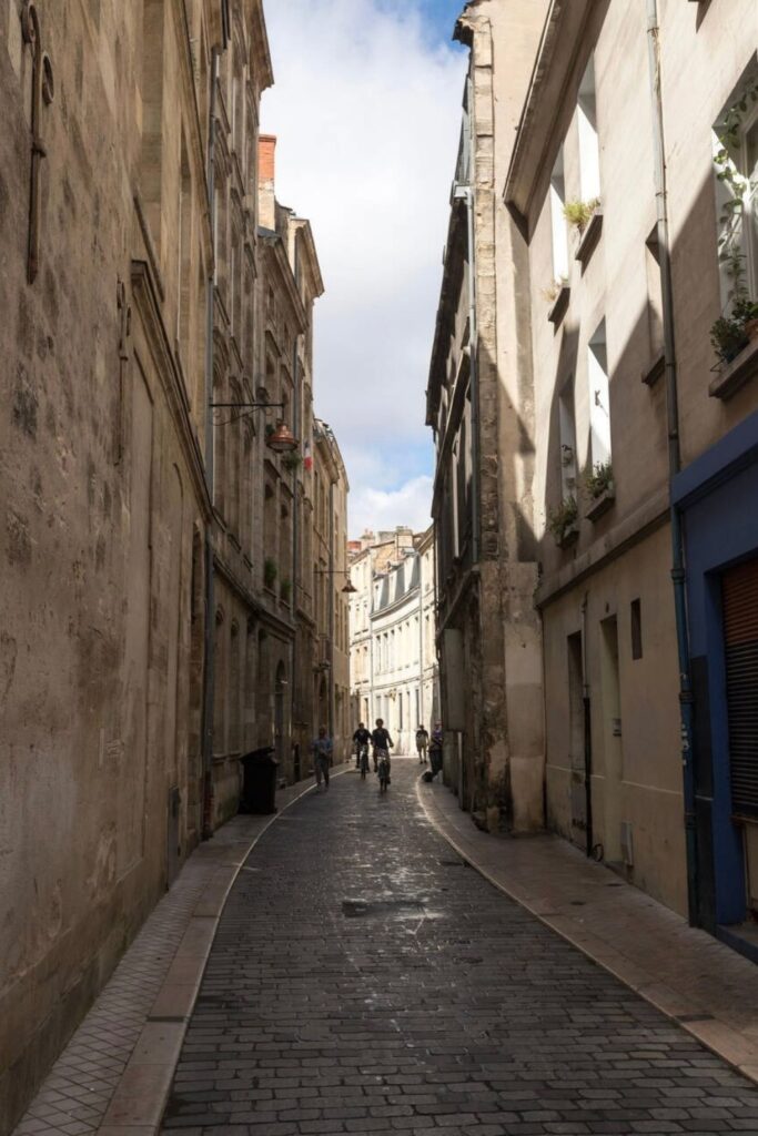 A narrow cobblestone street winds through Bordeaux’s historic center, inviting visitors to explore its charming architecture and hidden gems—one of the most authentic things to do in Bordeaux.