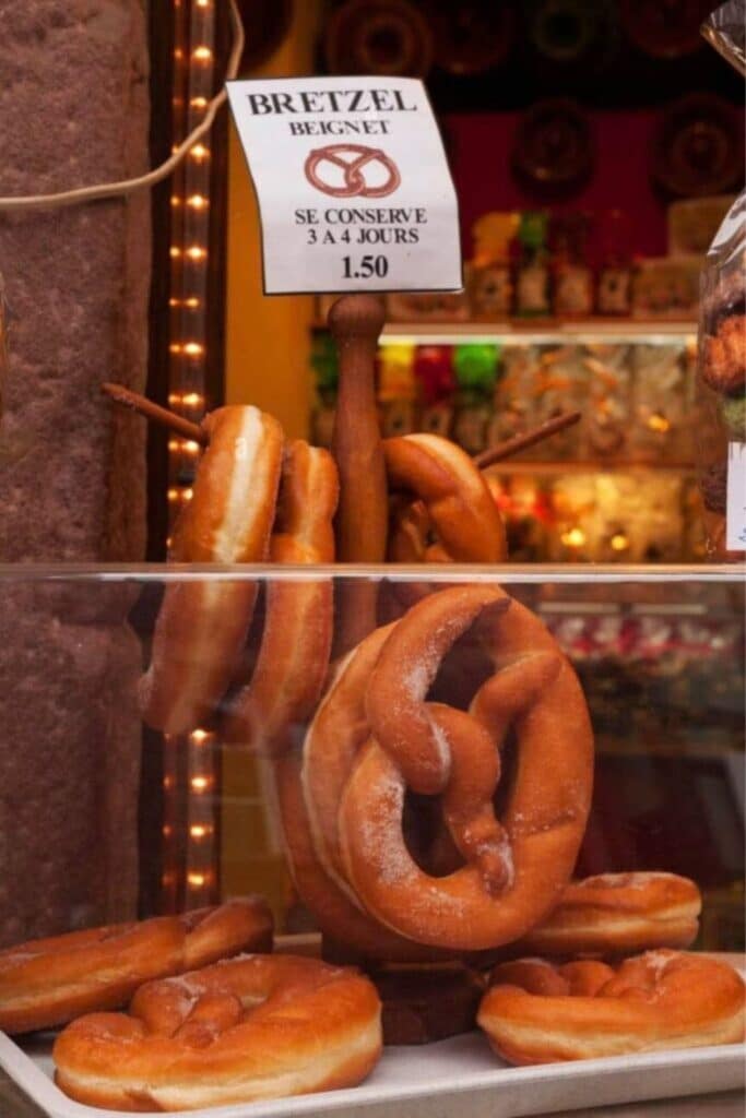 Freshly baked Bretzels (pretzels) on display in Riquewihr, a delightful place to visit in Alsace, offering delicious regional pastries.