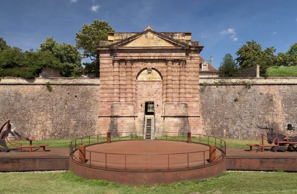Entrance to the Vauban fortifications in Neuf-Brisach, a UNESCO World Heritage site and one of the historical places to visit in Alsace, featuring impressive military architecture.