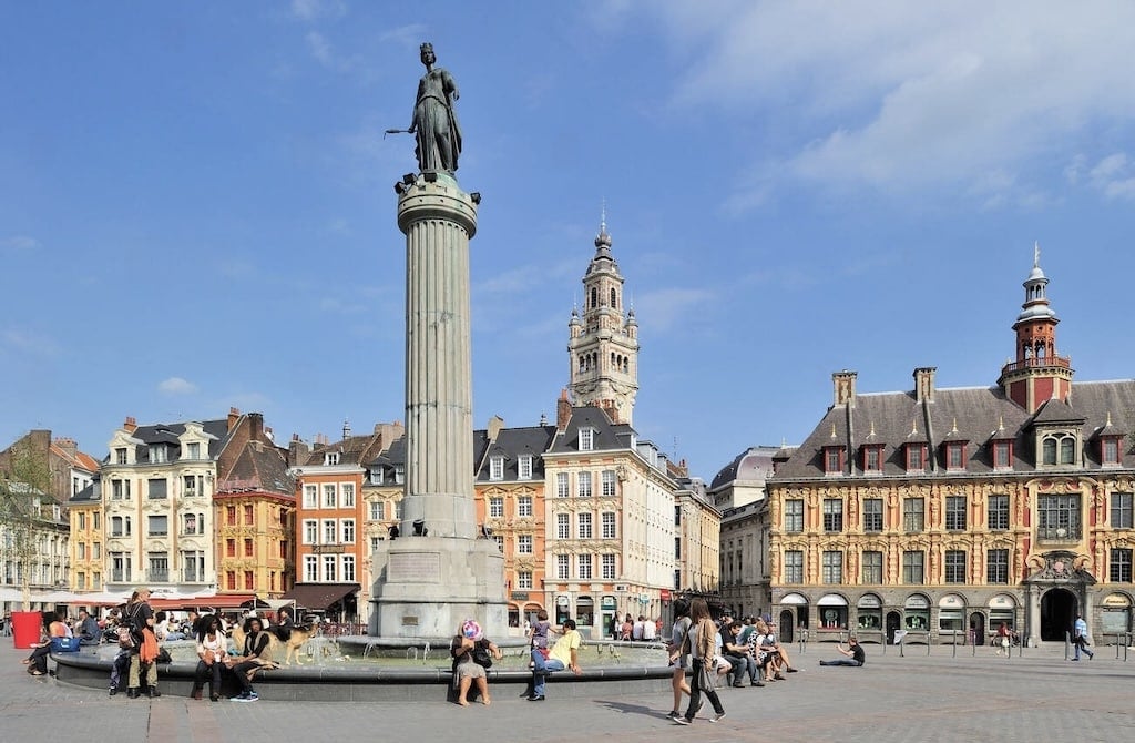 The lively Grand Place in Lille, with its historic architecture and iconic Column of the Goddess, is a popular destination for day trips from Paris France.
