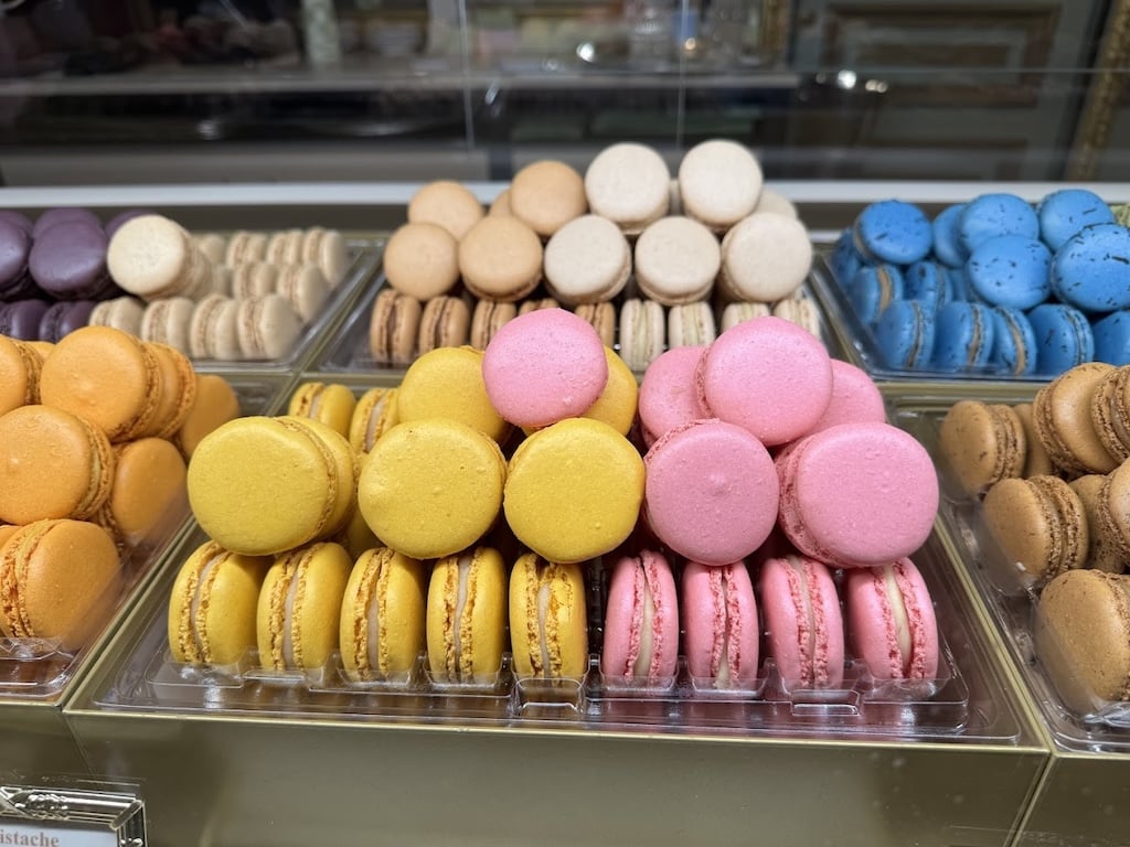 An assortment of colorful macarons, a delicate and iconic dessert that represents the elegance of traditional French foods.