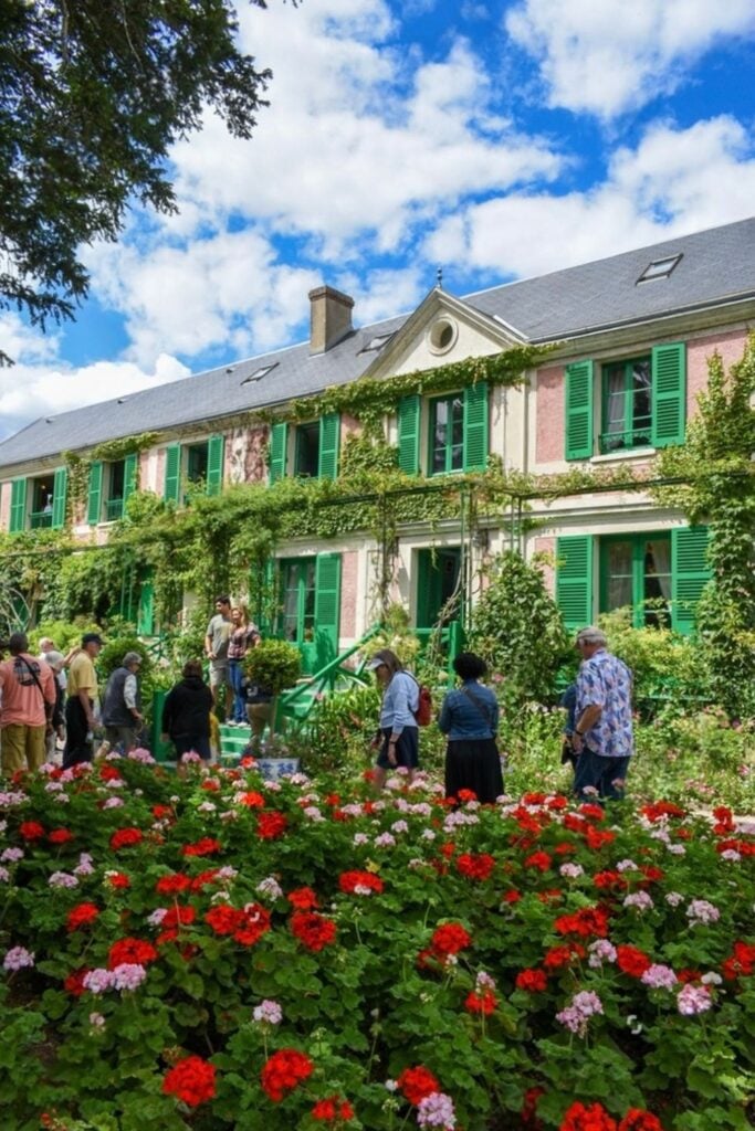 Claude Monet's house in Giverny, with its ivy-covered facade and vibrant flower gardens, offers a picturesque retreat for art and nature lovers on day trips from Paris France.