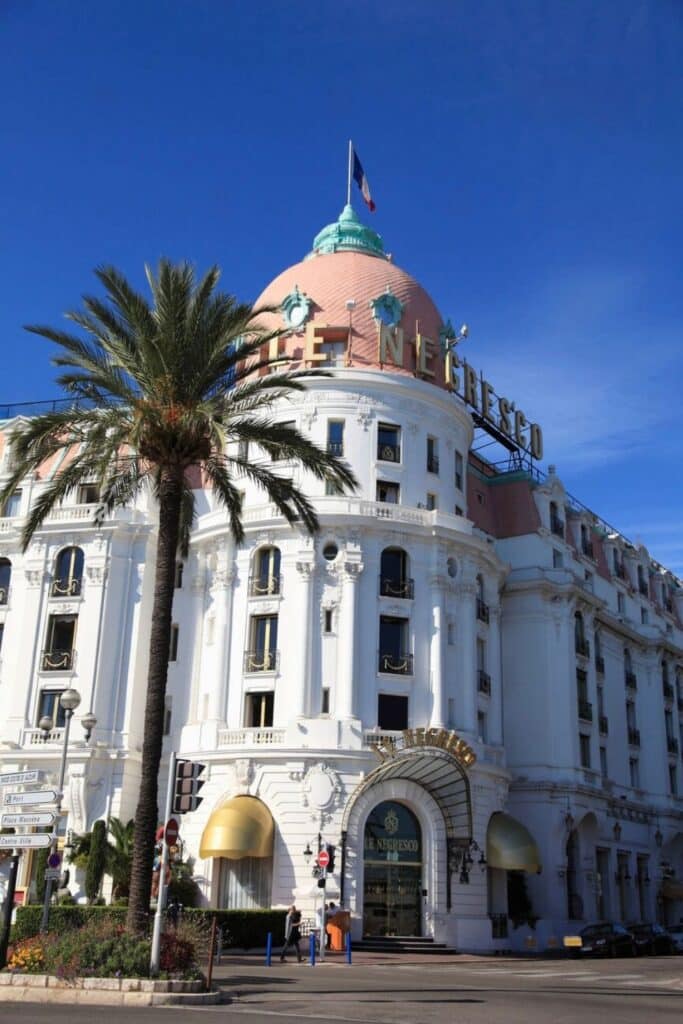 The iconic Hôtel Negresco, with its elegant Belle Époque architecture, pink dome, and French flag waving above, stands as a symbol of luxury on the Promenade des Anglais—one of the most famous things to do in Nice for history and glamour.