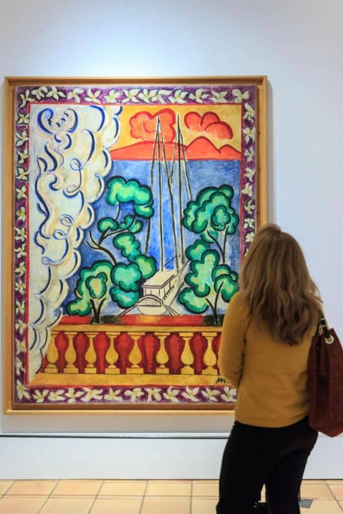 A visitor admires a vibrant Henri Matisse painting at the Musée Matisse in Nice, a must-visit destination for art lovers and one of the top cultural things to do in Nice.