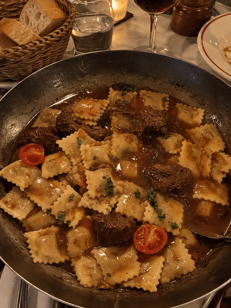 Traditional Raviolis Niçois served with a rich beef daube sauce, tender slow-cooked beef, tomatoes, herbs, and vegetables, a classic Niçoise specialty from Nice, France