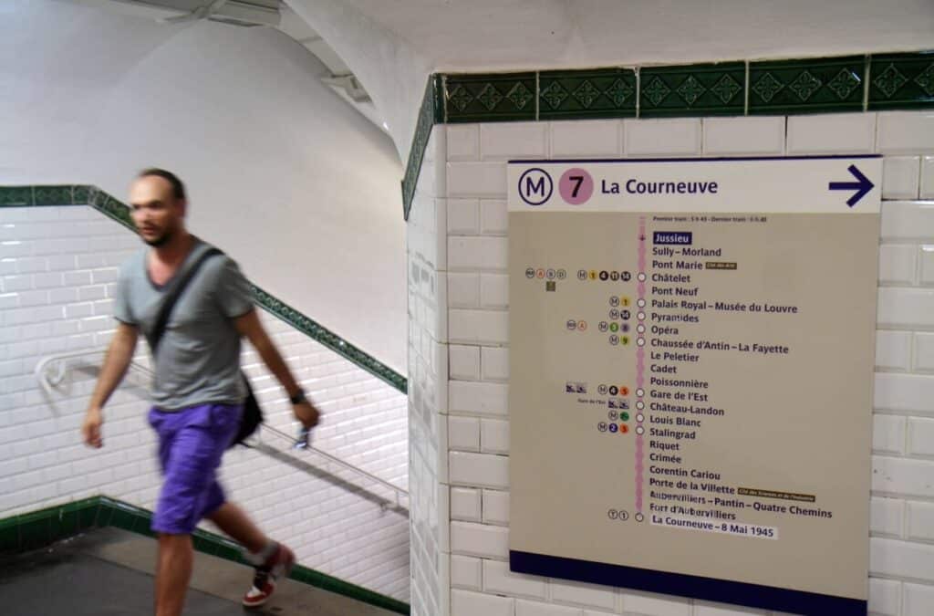 A Paris Metro Line 7 route map displayed inside Jussieu station, showing how to navigate directions when learning how to use the metro in Paris.