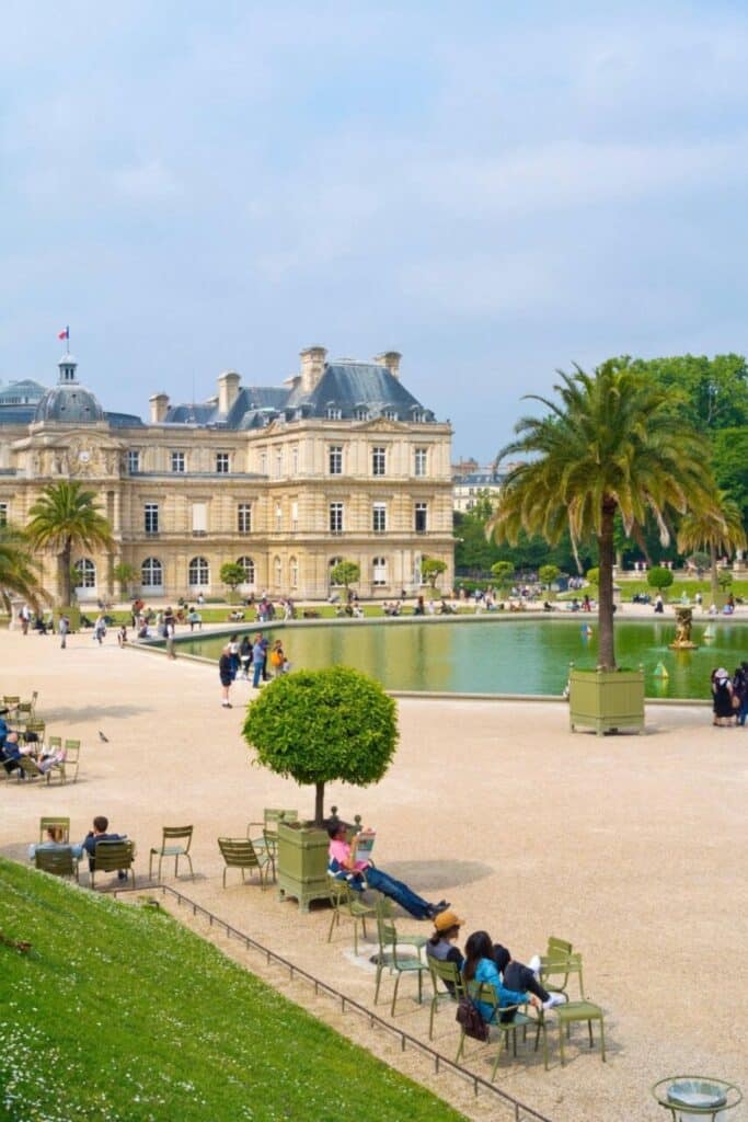 Families and visitors relaxing near the pond at Jardin du Luxembourg in Paris’ Saint-Germain district—an excellent choice when deciding where to stay in Paris with kids who love gardens, pony rides, and sailboat play.