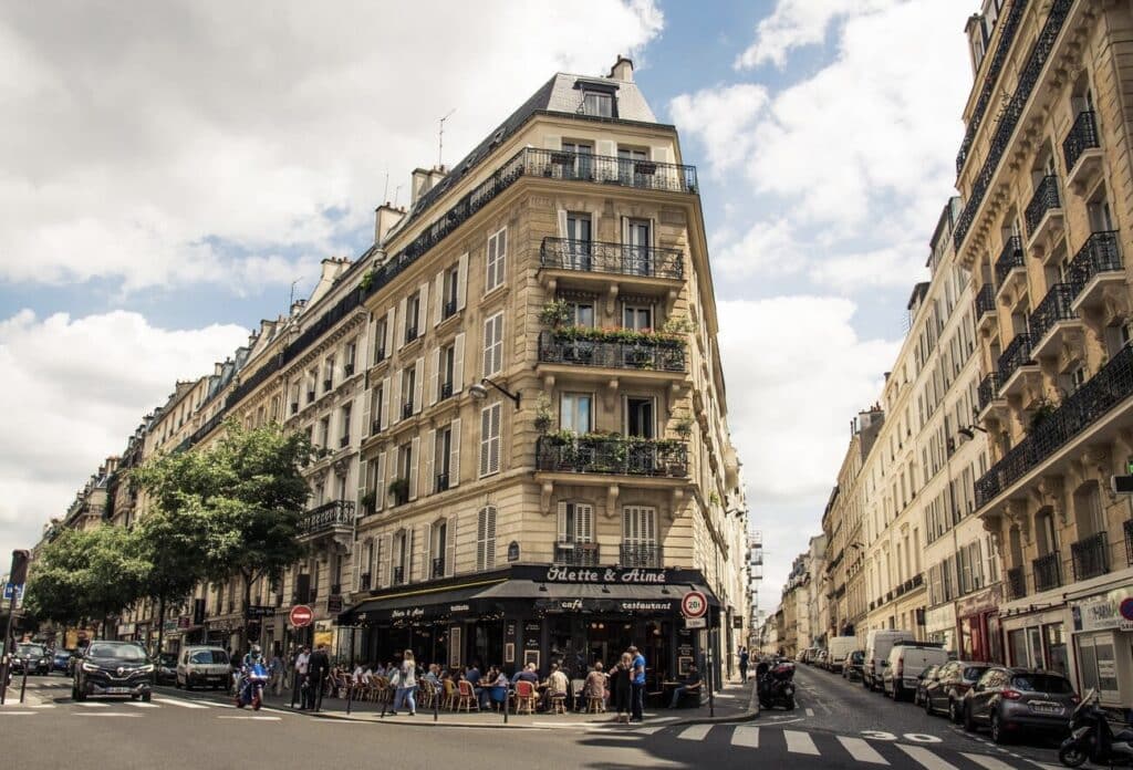 Charming corner café and classic Haussmann buildings in South Pigalle, 9th arrondissement—a lively, stylish area to consider when deciding where to stay in Paris for first-timers looking to blend local charm with trendy vibes.